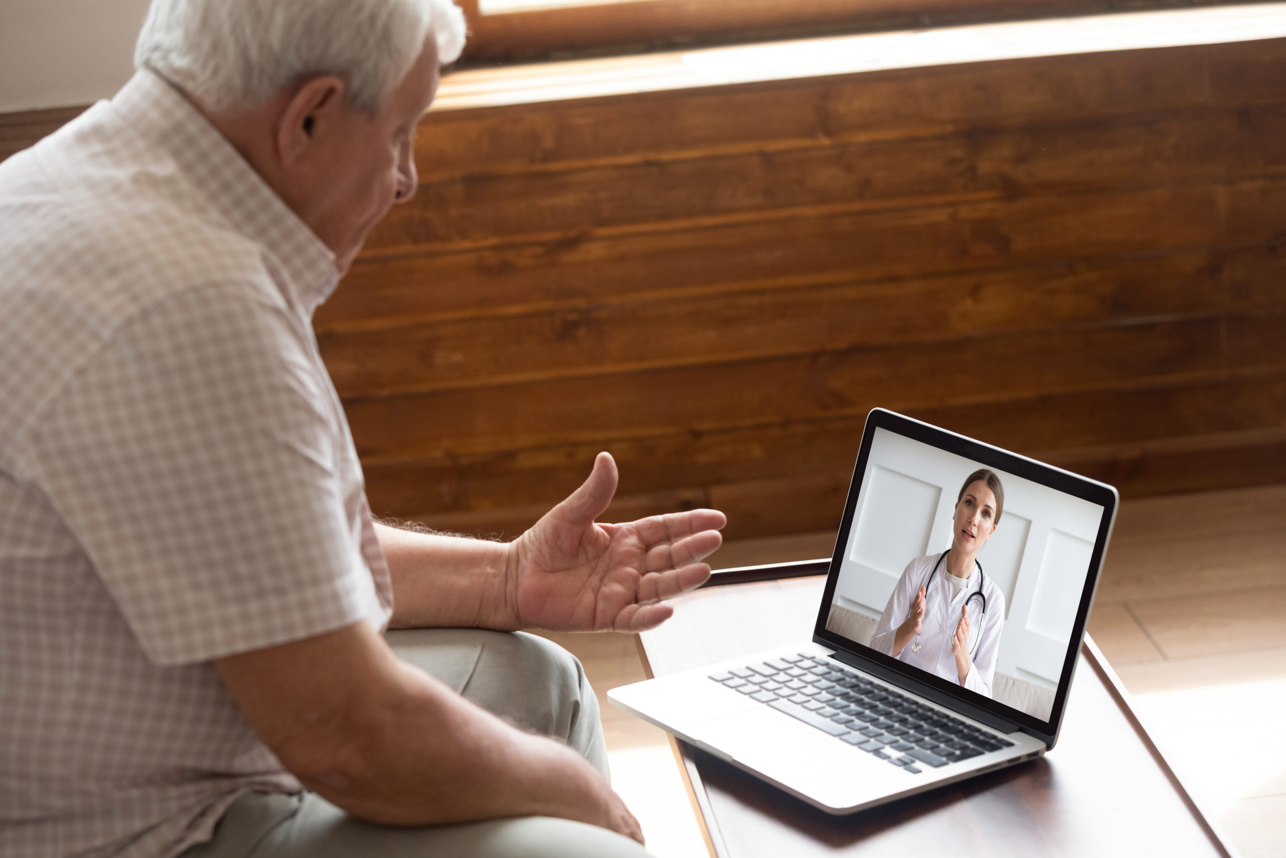 man attending virtual nurse appointment